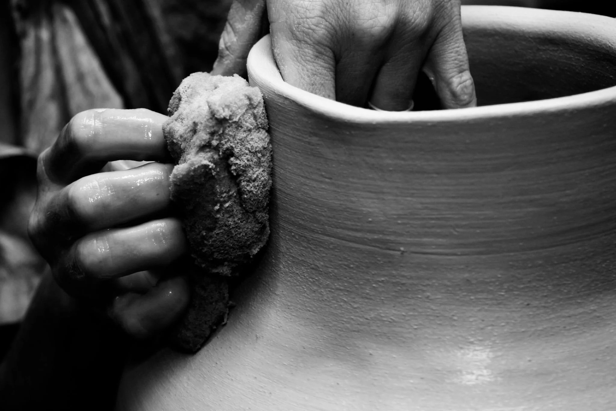 A potter molding clay into a shape